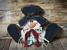 a snowman made out of wood and fabric