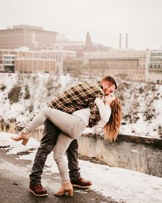 a man and woman kissing in the snow