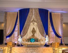 a banquet hall decorated in gold and blue