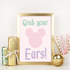 a pink and purple poster with the words grab your ears on it next to other items