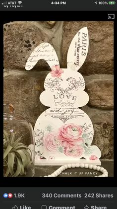 an easter card with a bunny on it and some flowers in the vase next to it