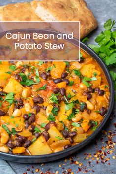 cajun bean and potato stew in a black bowl with parsley on the side