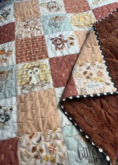 two quilts with owls and flowers on them are laying on the floor next to each other