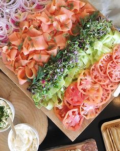 an assortment of food is laid out on a cutting board and ready to be eaten