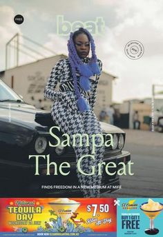 a woman standing next to a car in front of a building with the words sampa the great on it