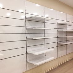 empty shelves are lined up against the wall