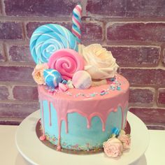 there is a cake decorated with candy and lollipops