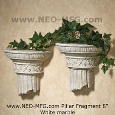 two white planters with ivy growing on them