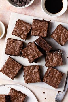 chocolate brownies on a cutting board next to coffee