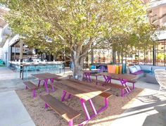 an outdoor seating area with benches and tables