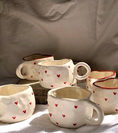 a group of coffee cups with hearts painted on them