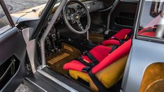 the interior of a car with red and yellow seats