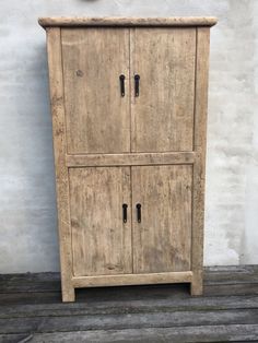 an old wooden cabinet with two doors on the front and one door open to reveal a clock