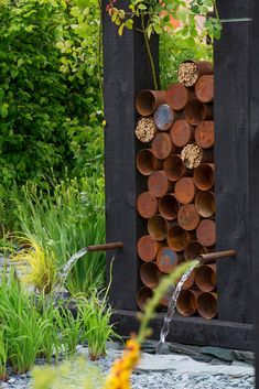 an outdoor fountain made out of metal pipes