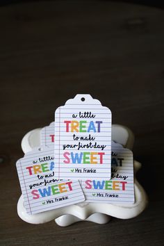 there are three tags that say treat to make your birthday sweet and one is written on the tag