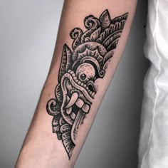 a black and white tattoo design on the arm