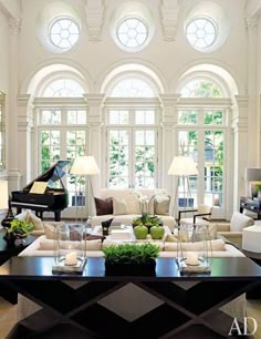 two pictures of a living room with couches, chairs and a piano in it