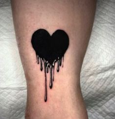 a heart shaped tattoo with dripping black paint