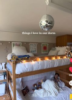 there are two bunk beds with lights on the bottom and one has a mirror ball hanging from the ceiling