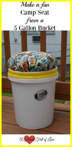 a white bucket filled with lots of different items on top of a wooden deck next to a fence