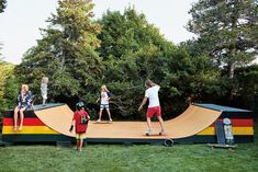 children are playing on a fake skateboard ramp