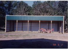 an old photo of a building with two garages