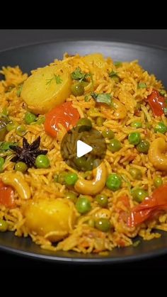 a black plate topped with rice and vegetables