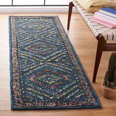 a blue runner rug with an intricate design