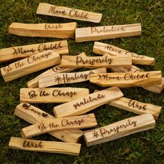 wooden name tags with names on them sitting in the grass, one is for each family member