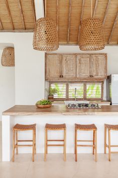 an island with four stools in front of it