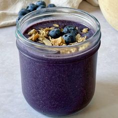 a glass jar filled with blueberries and oatmeal next to a stuffed animal