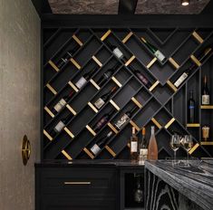 a black bar with wine bottles and glasses on it