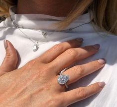 a close up of a person wearing a diamond ring