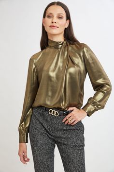 Shine bright in this season's must-have blouse. Chic and sophisticated, the draped neckline of our luxe metallic lamme blouse adds a modern edge that's effortlessly stylish. The relaxed fit and soft sleeves add a decidedly feminine touch to this must-have piece. Perfect for day-to-night transitions, this blouse is the ultimate expression of modern chic. Limited Edition 50th Anniversary Collection Elie Tahari Exclusive Long Sleeve Metallic Gold Lamme Draped Neck Shirt 100% Polyester Runs true to Satin Bluse, Metallic Blouses, Dolman Sleeve Sweater, Mock Neck Blouse, Mock Neck Top, Karl Lagerfeld Paris, Woven Top, E Bay, Lantern Sleeves