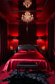 a bedroom with red walls, black furniture and a chandelier hanging from the ceiling