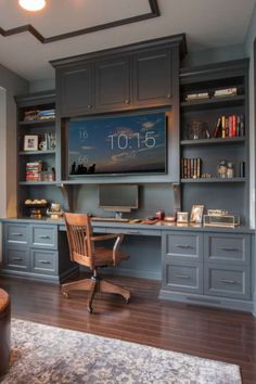 a home office with built - in desk and bookcases