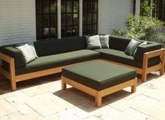 a couch and ottoman sitting on top of a patio