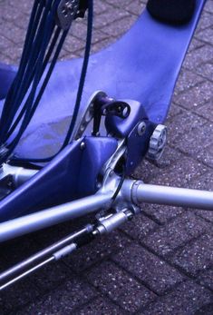 a close up view of the front end of a blue bicycle with its brake assembly missing