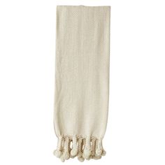 a white towel with tassels hanging from it's side on a white background