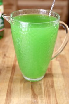 a green drink with a straw in it