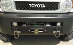 the front end of a white toyota truck