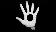 a person's hand is shown in the dark