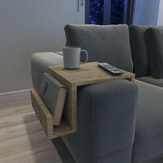 a couch with a coffee cup and book on it