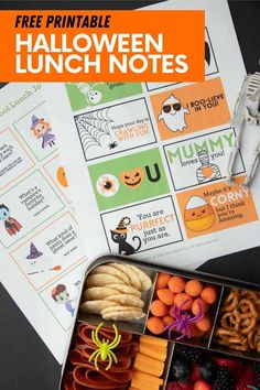 an open lunch box filled with halloween themed snacks and free printables for kids