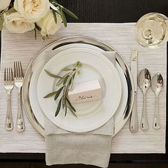 a place setting with silverware and napkins