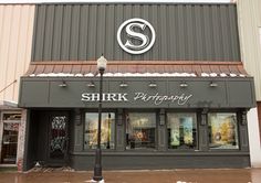 there is a store front with the word shirk photography on it's side