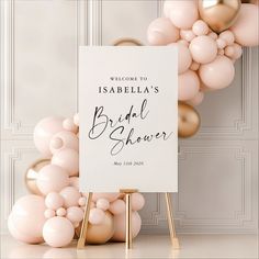 a welcome sign and balloon arch for a bridal shower at an elegant wedding reception