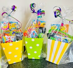 three bags filled with candy and candies on top of a counter next to each other