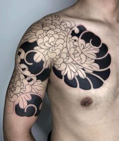 a man's chest with black and white flowers on it