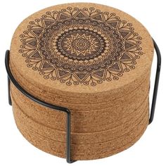 four cork coasters stacked on top of each other with a metal holder in the middle